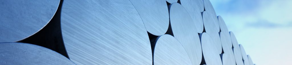 Stack of aluminium billets on a cloudy sky background. Suitable for any industrial related purposes.