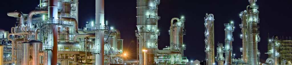 chemical and petrochemical machinery lighted up against the night sky
