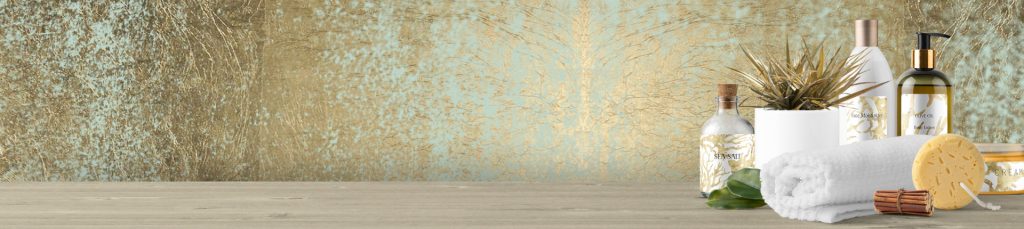 spa and cosmetic products arranged together in a corner with a gold background