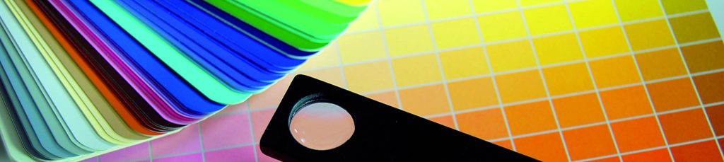 colour cards of different colours stacked and spread over yellow orange pink gradients