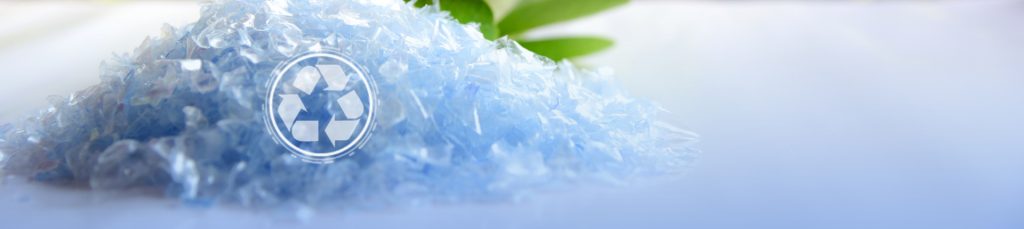 A Pile of PET bottle flakes with green tree blur background.Recycle icon,picking up Plastic Bottle,PET icon&Compress bale icon.Save environment concept