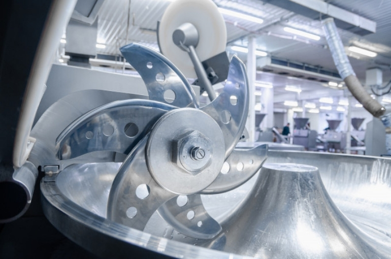 up-close image of food processing machinery in a factory setting